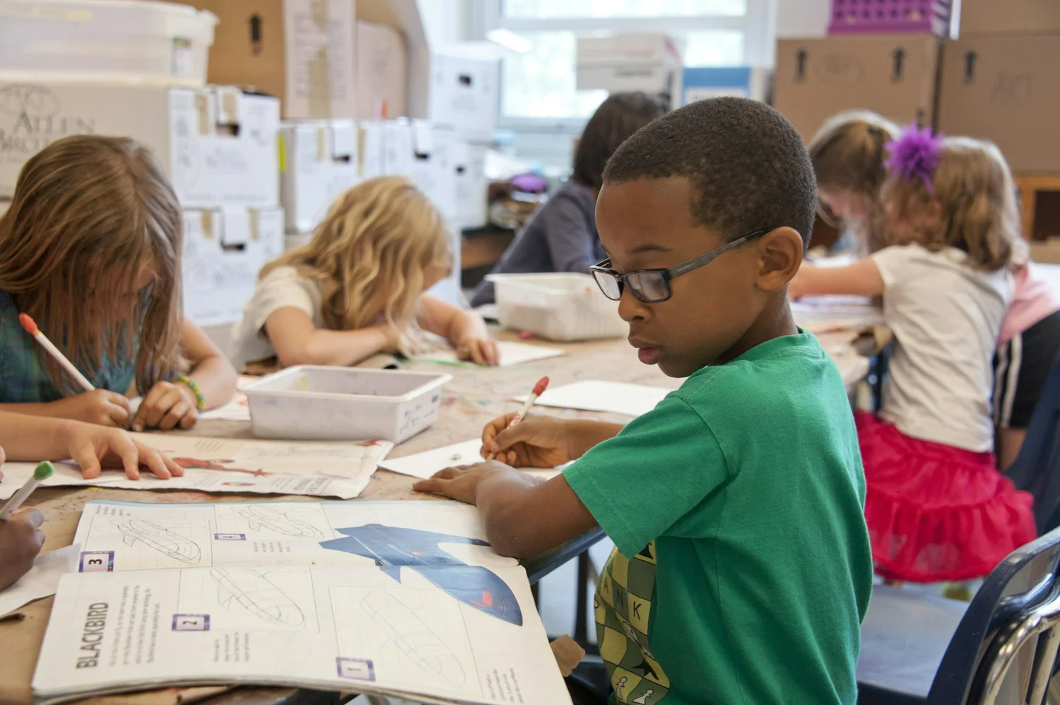 A young student focused on their work